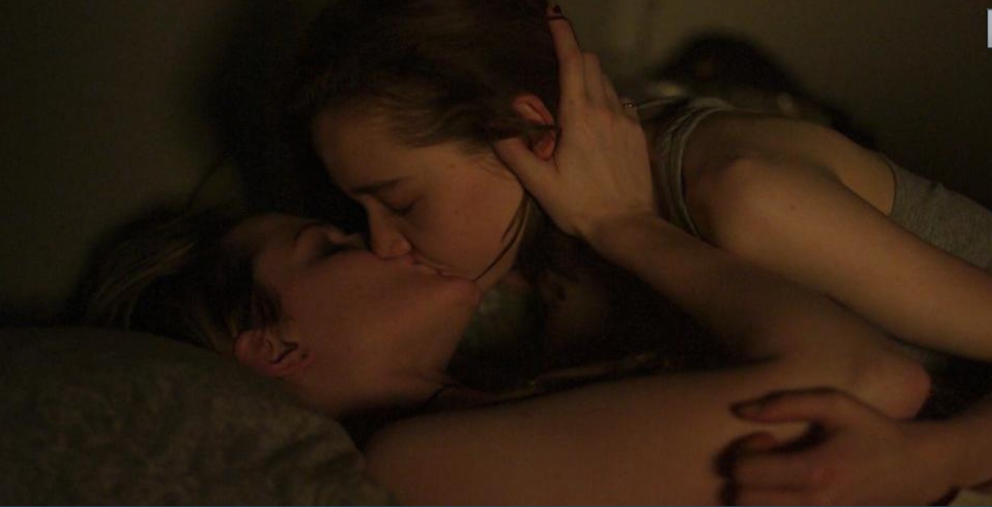 Evan Rachel Wood lying on her back with Julia Sarah Stone making out with her.